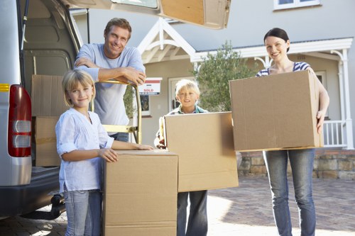 Movers carrying household furniture with care